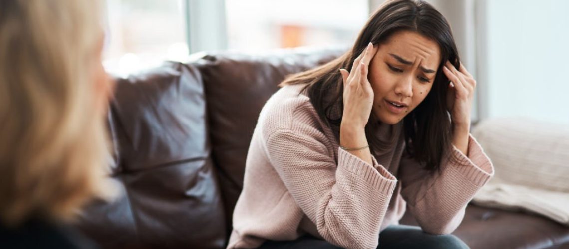 Shot of a young woman having a therapeutic session with a psychologist